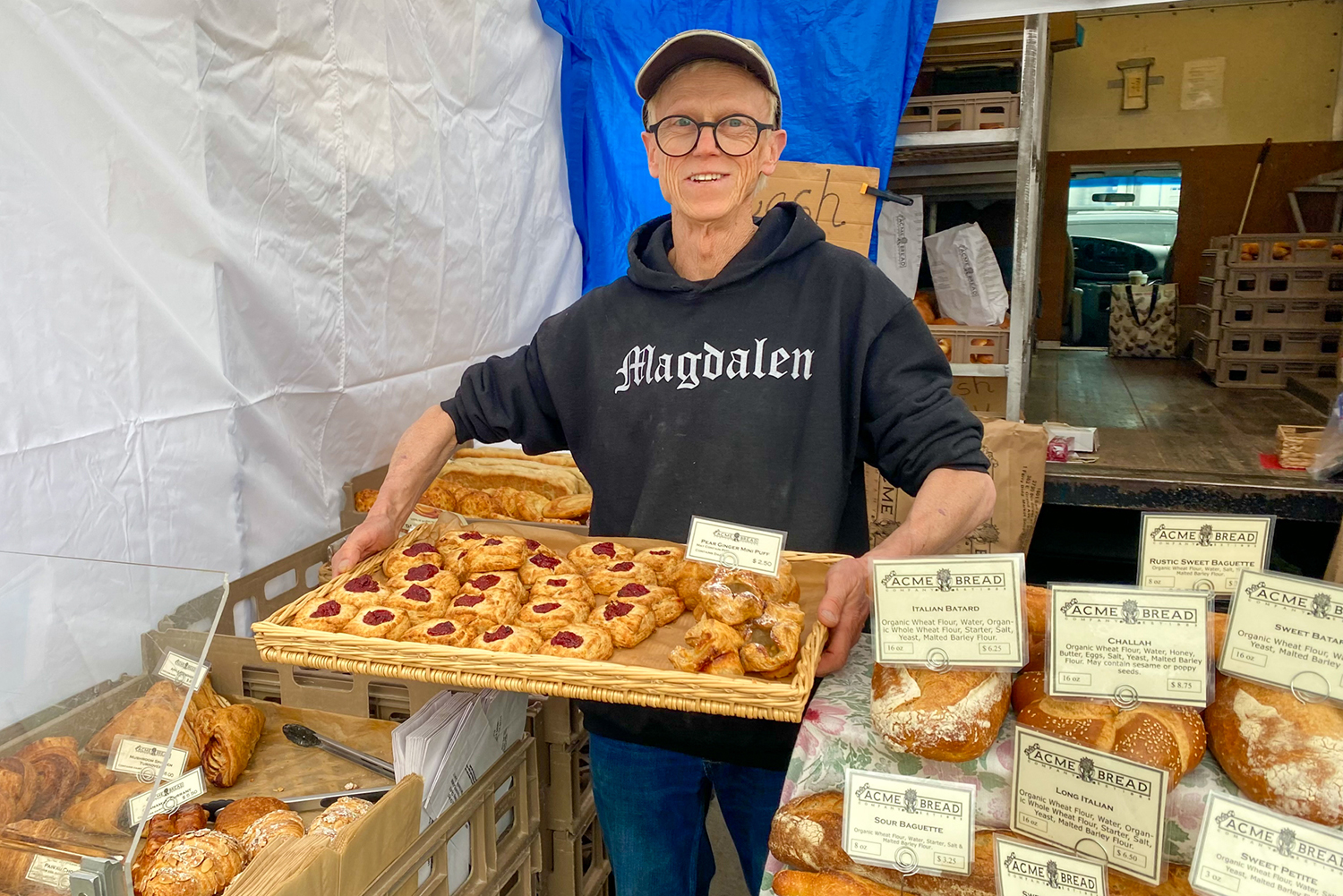 Someone holding a tray of pastries at Acme's stand at Ferry Plaza Farmers Market