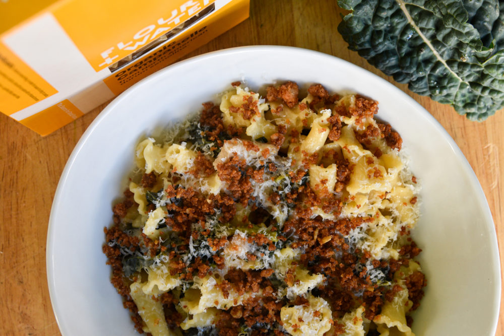 A bowl of campanelle with mushrooms and kale, made with Flour+Water dried pasta (box of pasta shown in top left corner)