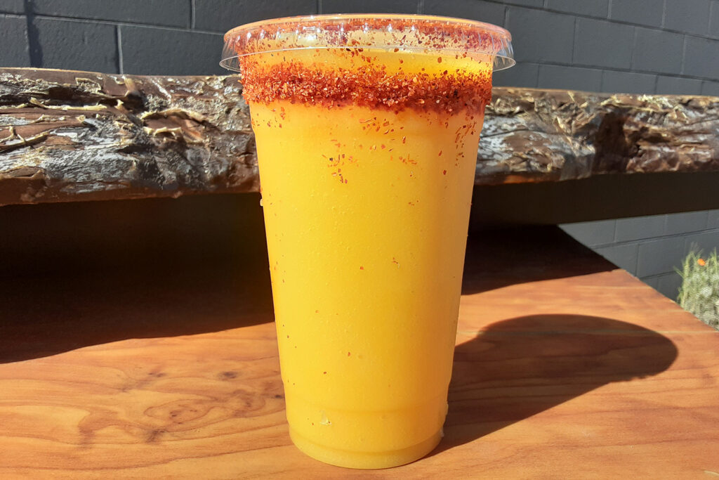 Mango smoothie with tajin on the rim